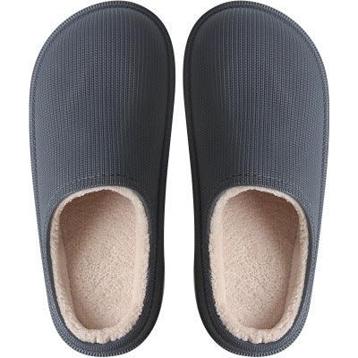 Top view of cozy gray slippers with soft beige fleece lining on white background