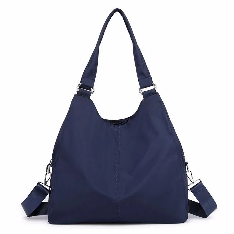 Navy blue casual shoulder bag with adjustable straps and silver hardware
