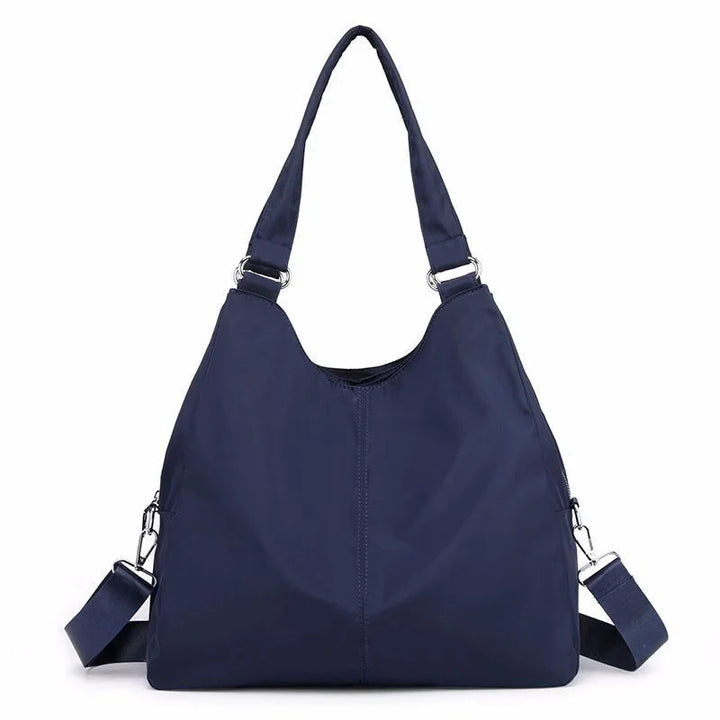 Navy blue casual shoulder bag with adjustable straps and silver hardware