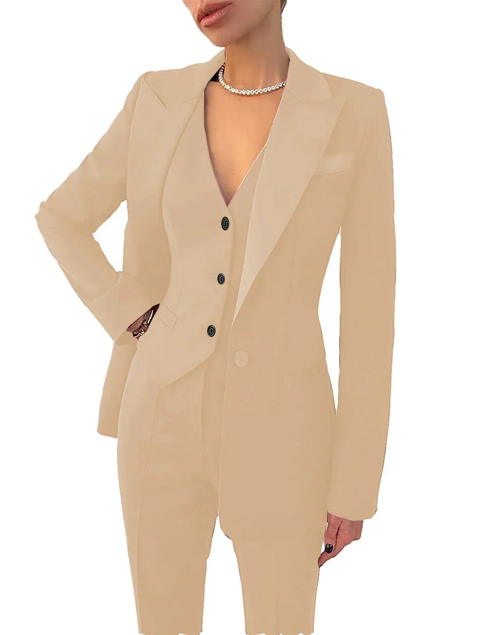 Woman wearing beige tailored suit with blazer, vest, trousers, and pearl necklace
