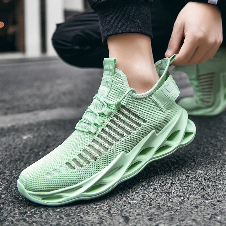 Light green breathable mesh running sneaker with hollow sole design on asphalt