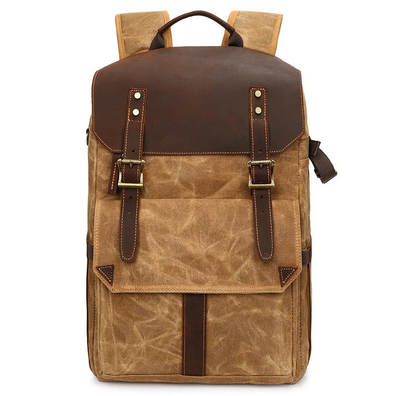 Vintage canvas and leather backpack with front flap, buckle straps, and top handle