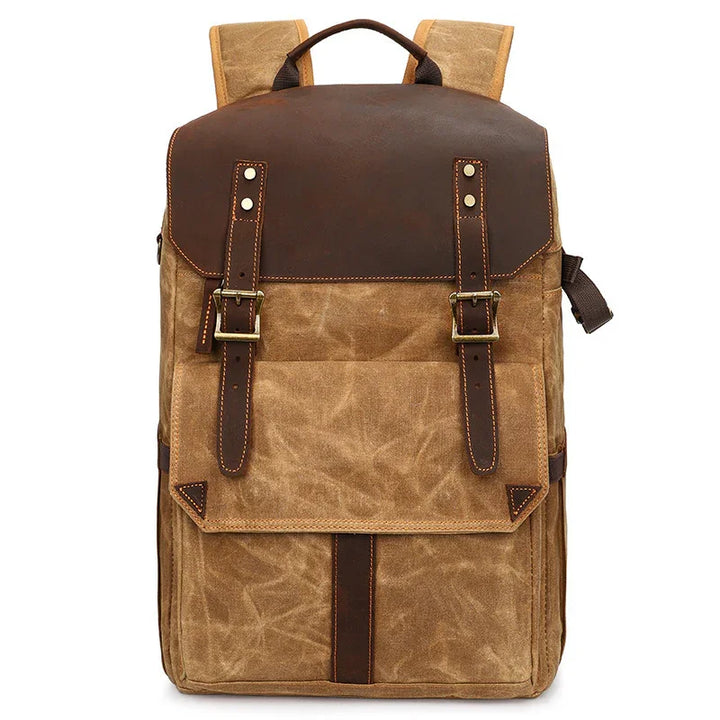 Vintage canvas and leather backpack with front flap, buckle straps, and top handle