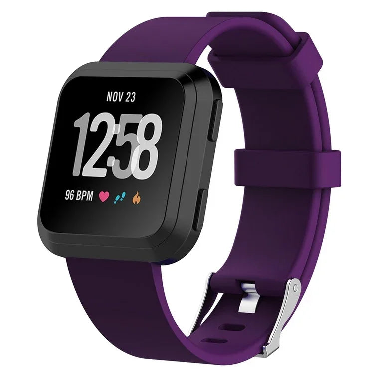 Black smartwatch with purple silicone band showing time, heart rate, steps, and calories burned