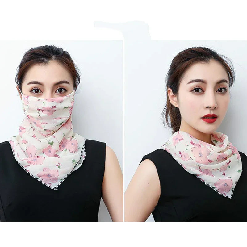 Woman wearing a pink floral face scarf and styled as a neck scarf in black sleeveless top