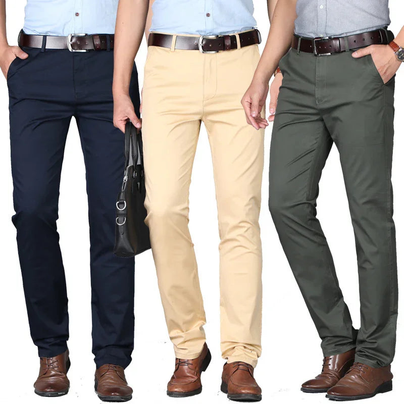 Men wearing slim fit chinos in navy blue, beige, and olive green, paired with brown belts and dress shoes
