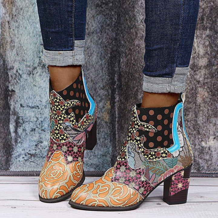 Colorful patchwork ankle boots with floral and polka dot patterns worn with cuffed dark jeans