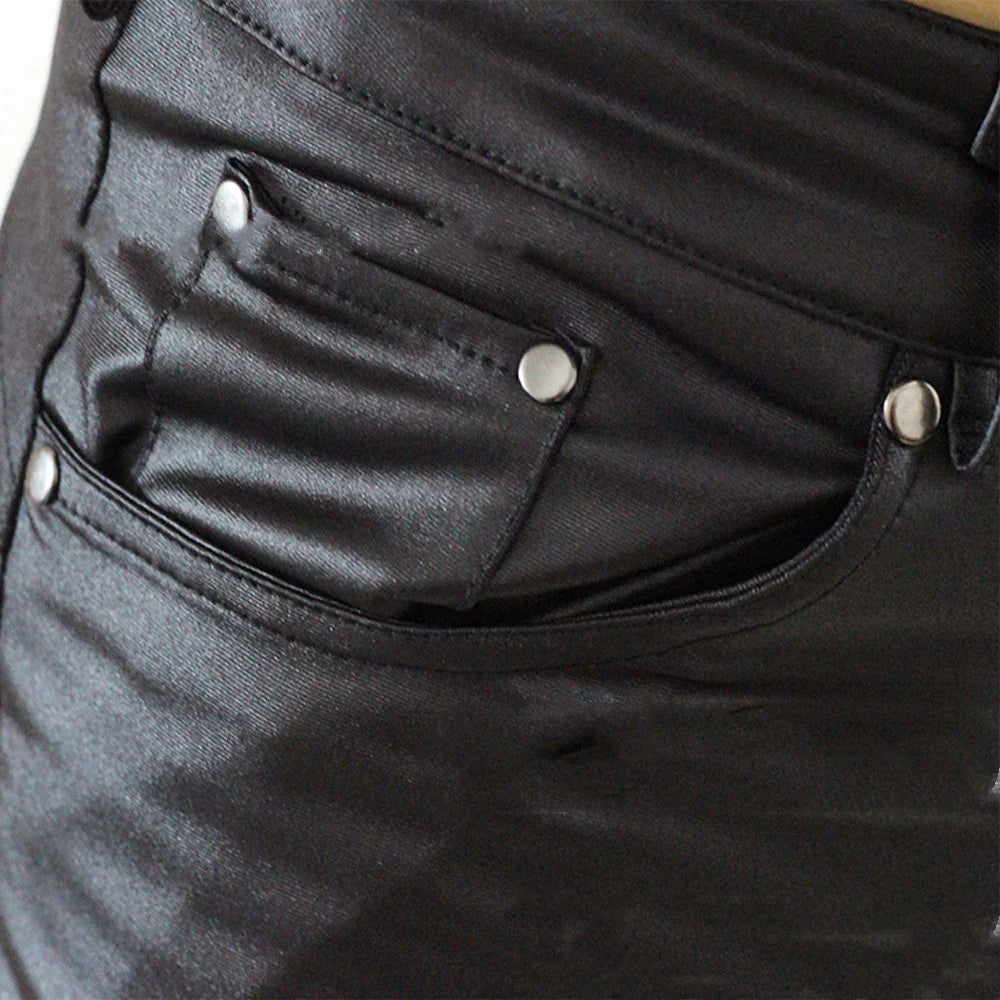 Close-up of black leather jeans pocket with silver rivets and stitching details