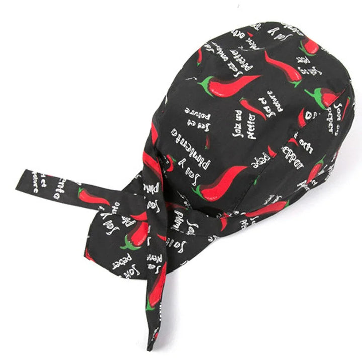Black chef skull cap with red chili pepper print and white text saying 'Saz cay piper'