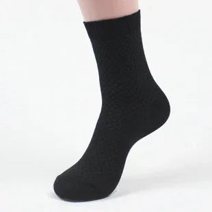 Black textured ankle sock on a mannequin foot against white background