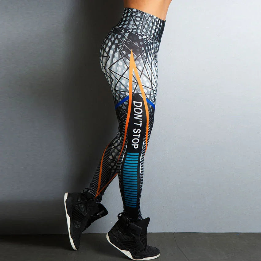 Woman wearing high-waisted colorful patterned leggings with 'DON'T STOP' text and black athletic shoes