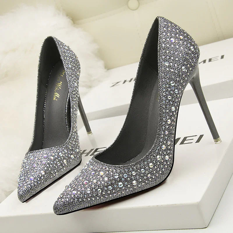 Pair of silver crystal-embellished high heel stiletto shoes on white boxes