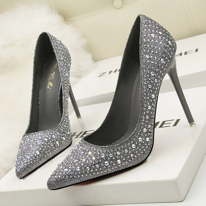 Pair of silver crystal-embellished high heel stiletto shoes on white boxes