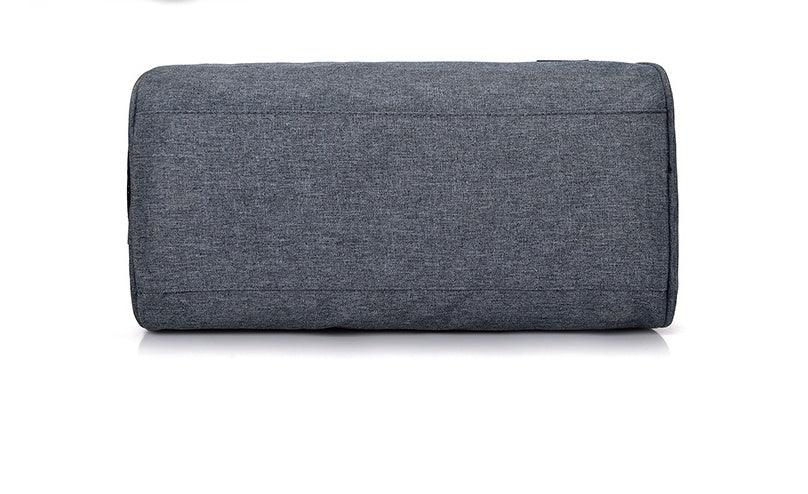 Close-up of a rectangular grey fabric sofa armrest with simple stitching on a white background