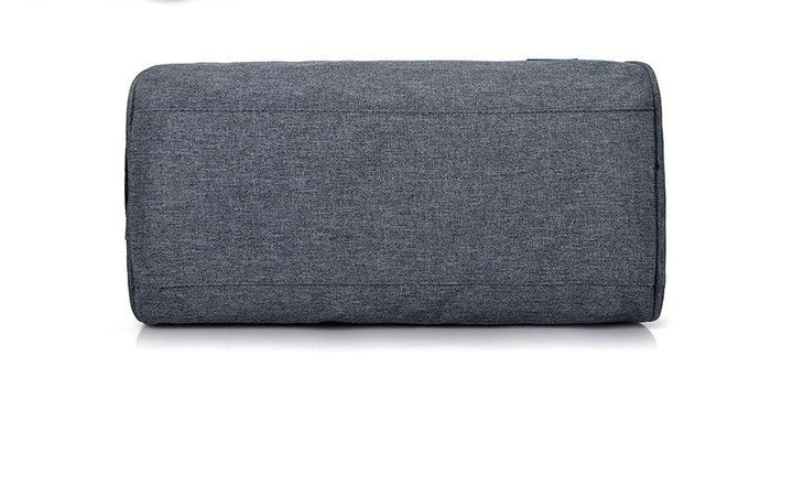 Close-up of a rectangular grey fabric sofa armrest with simple stitching on a white background