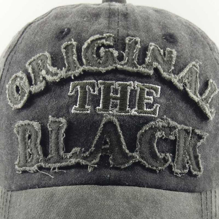 Worn black baseball cap with distressed embroidered text 'ORIGINAL THE BLACK' on front