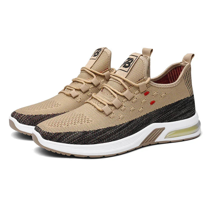 Beige and black knitted running shoes with white cushioned sole and pull tab
