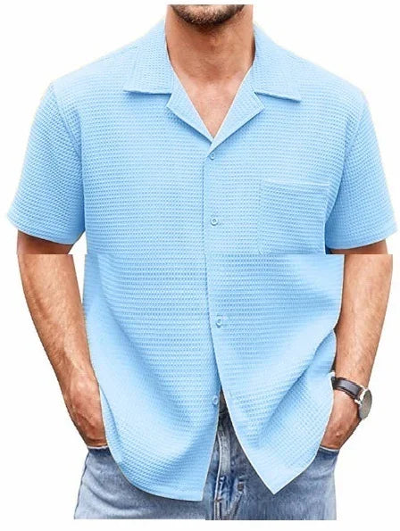 Men's light blue textured short-sleeve button-up shirt with camp collar and front pocket