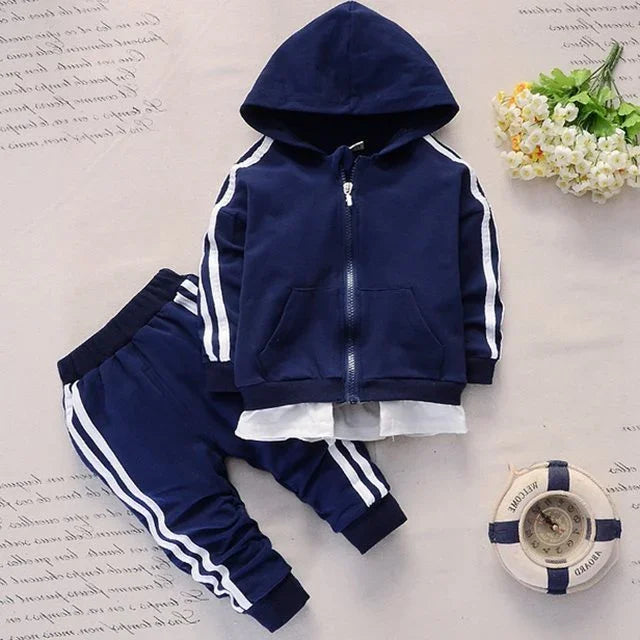 Navy blue toddler tracksuit with white stripes, hoodie and pants set, styled with white flower bouquet