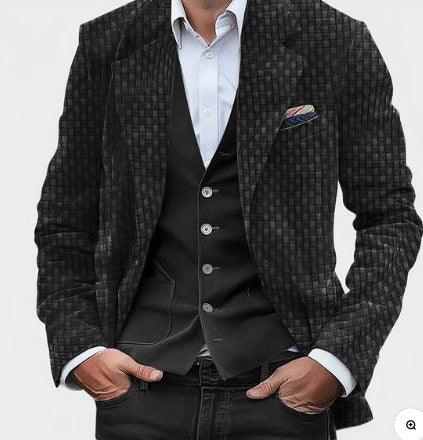 man in black textured blazer and black vest with white dress shirt and pocket square