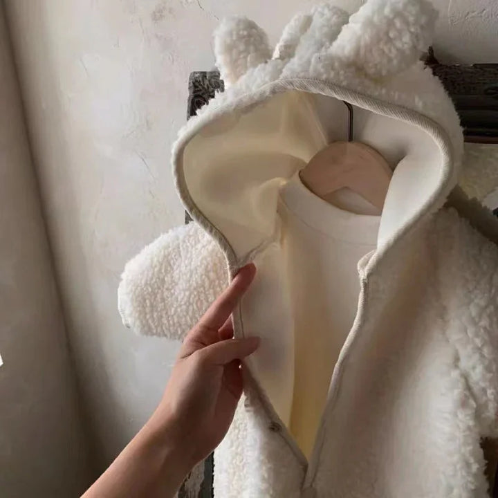 White fluffy baby hoodie with bear ears on hanger, cozy toddler outerwear in soft sherpa fabric