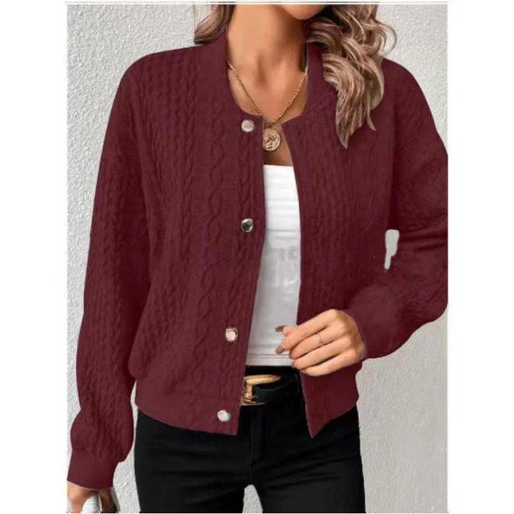 Woman wearing maroon cable knit button-up cardigan with white top and black pants, gold necklace