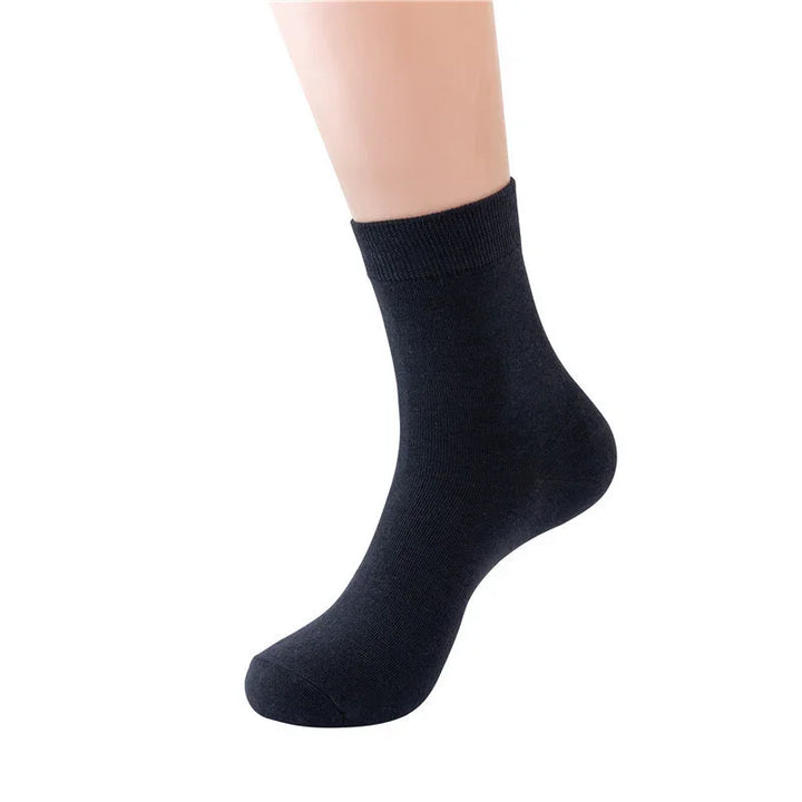 Black cotton ankle sock on mannequin foot with ribbed cuff, isolated on white background