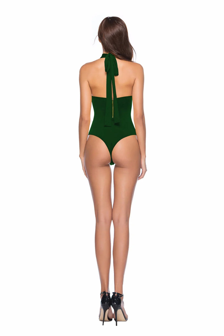 Woman wearing dark green halter neck thong bodysuit and black high heels, viewed from back