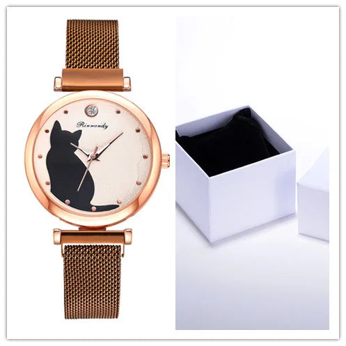 Rose gold wristwatch with black cat silhouette dial and mesh strap next to open white gift box