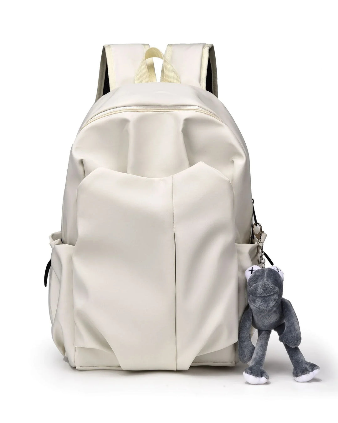 White backpack with padded straps and front pockets, featuring a gray plush frog keychain