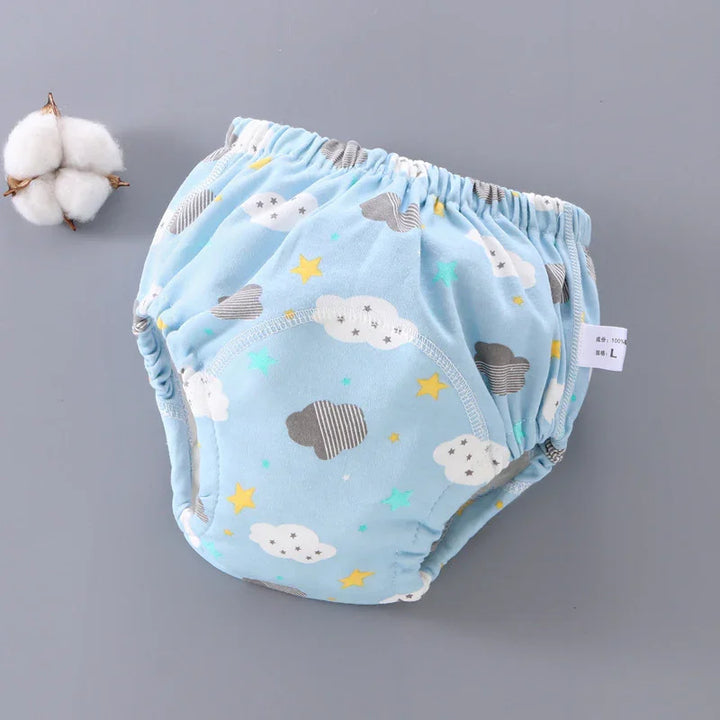 Blue baby training pants with cloud and star print on gray background and cotton boll