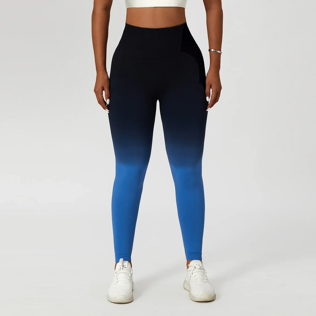 Woman wearing high waisted blue ombre leggings and white sneakers, front view