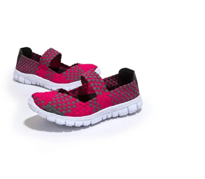 Pair of pink and gray woven slip-on shoes with white flexible soles on white background
