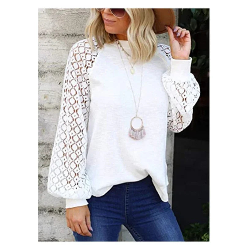 Woman wearing white lace sleeve blouse with blue jeans and long pendant necklace