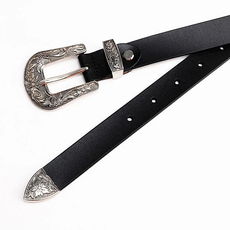 Black leather belt with ornate silver floral engraved buckle, loop, and tip on white background