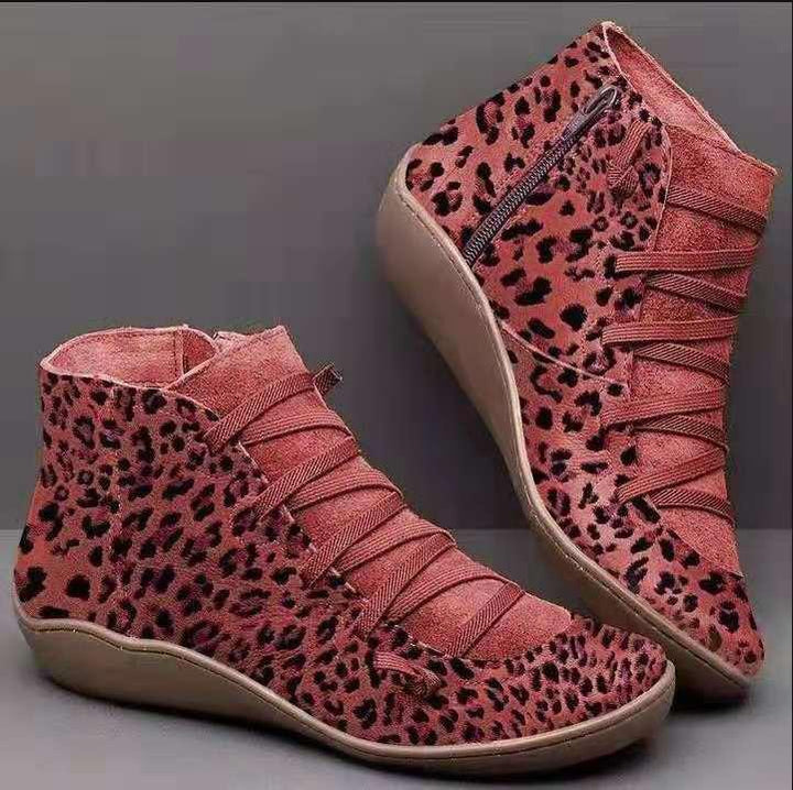 Red leopard print women's ankle boots with side zipper and beige sole on gray background