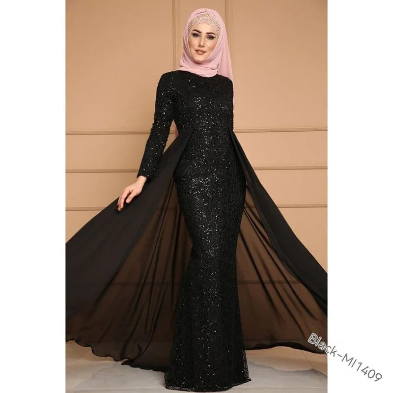 Elegant woman wearing a black sequined evening gown with sheer flowing train and pink hijab