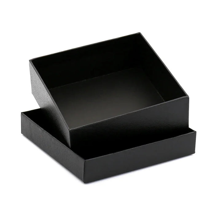 Open black textured square gift box with detached lid on white background