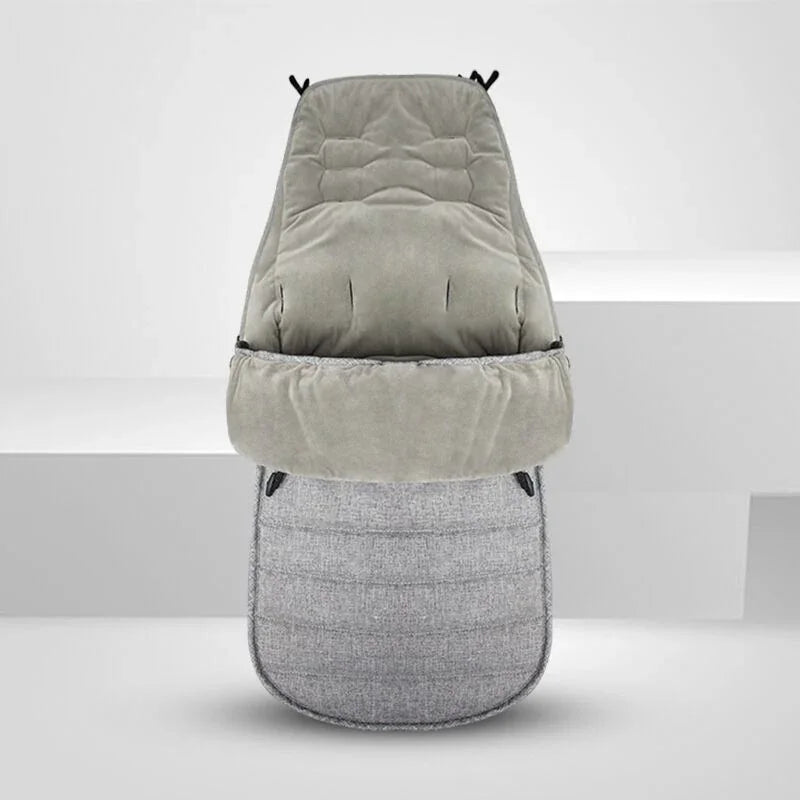 grey cushioned baby stroller footmuff with soft, quilted fabric and adjustable openings
