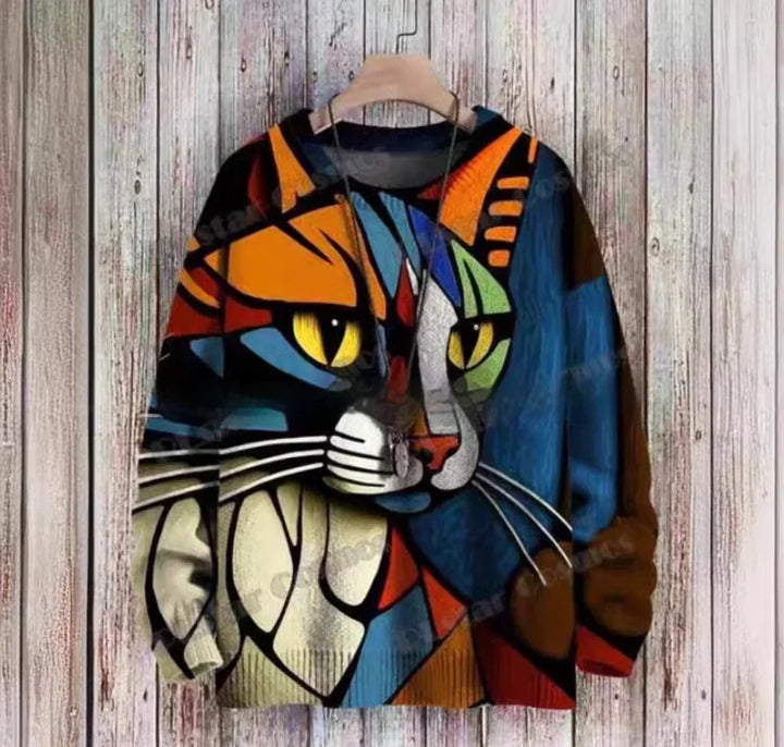 Colorful geometric cat face printed on a long-sleeve sweater hanging on wooden wall