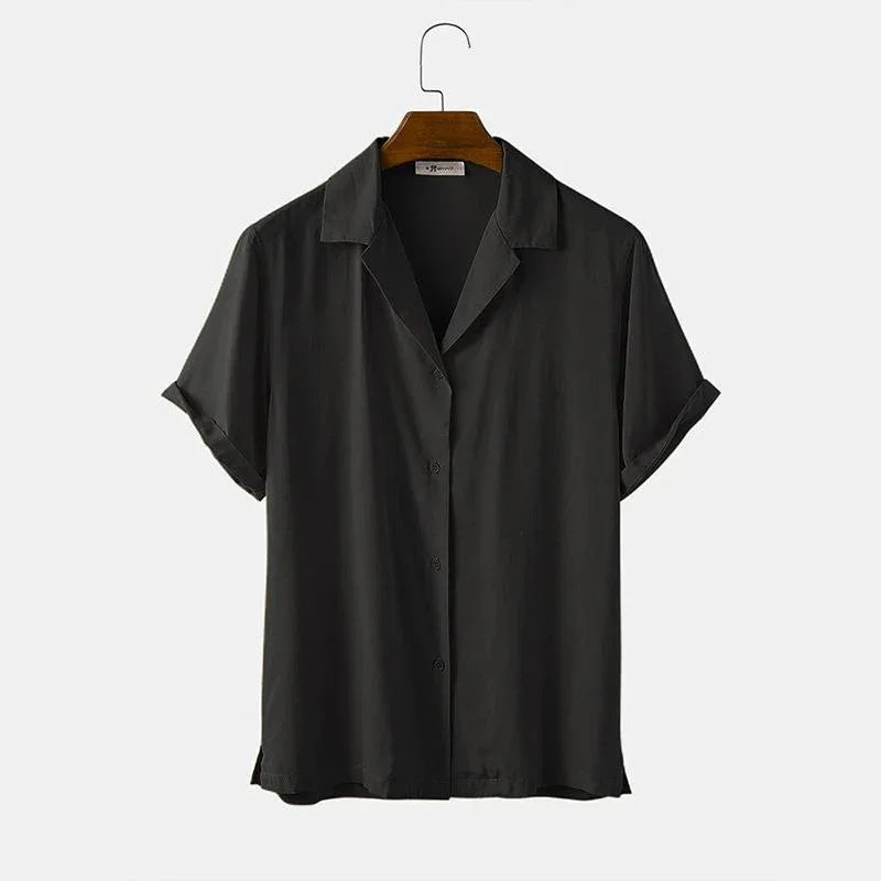 Black short-sleeve button-up shirt with collar on wooden hanger against white background
