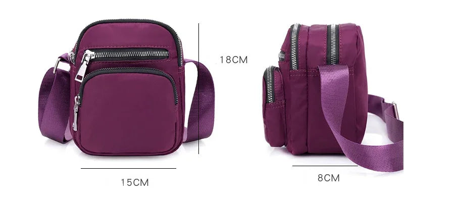 Compact purple crossbody bag with multiple zippered compartments, adjustable strap, 15x18x8 cm size