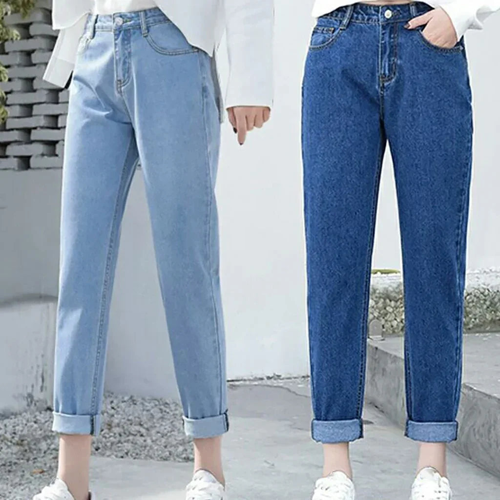 Two models wearing light blue and dark blue rolled-up denim jeans with white sneakers