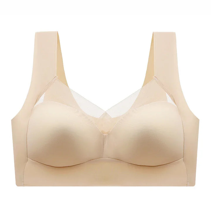 Beige seamless wireless bra with wide straps and mesh accents, front view on white background