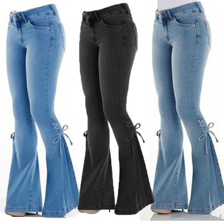 Three pairs of women's flared jeans in light blue, black, and medium blue with side lace-up details