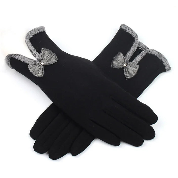 Pair of black winter gloves with gray knitted trim and decorative bow on white background