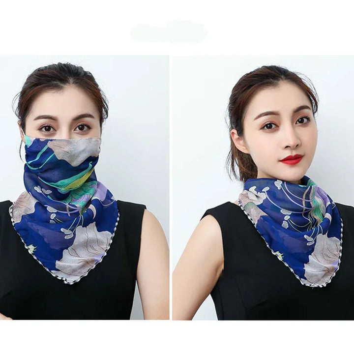 Woman wearing a blue floral patterned scarf styled as neckwear and face cover, against a plain white background