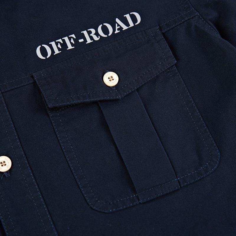 Close-up of navy blue fabric pocket with button and white off-road text on rugged clothing