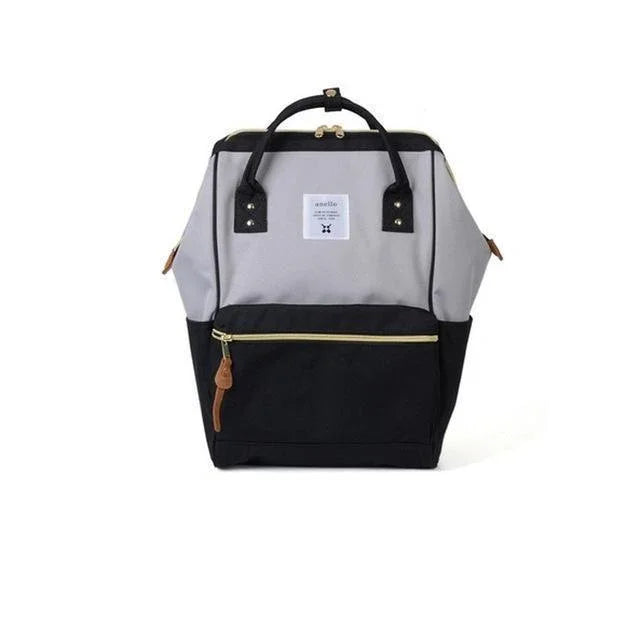 Two-tone gray and black backpack with front zipper pocket and top handles on white background