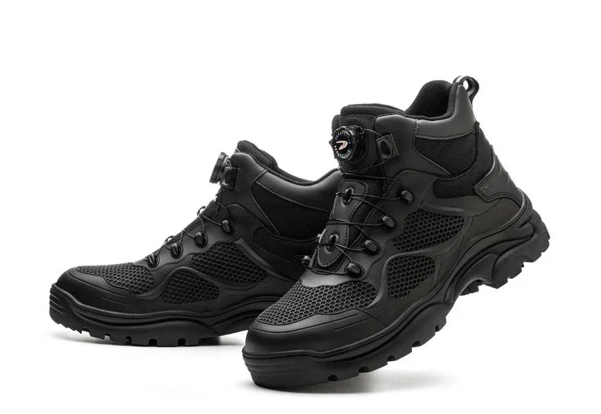 Pair of black high-top hiking shoes with mesh panels and rugged soles on white background